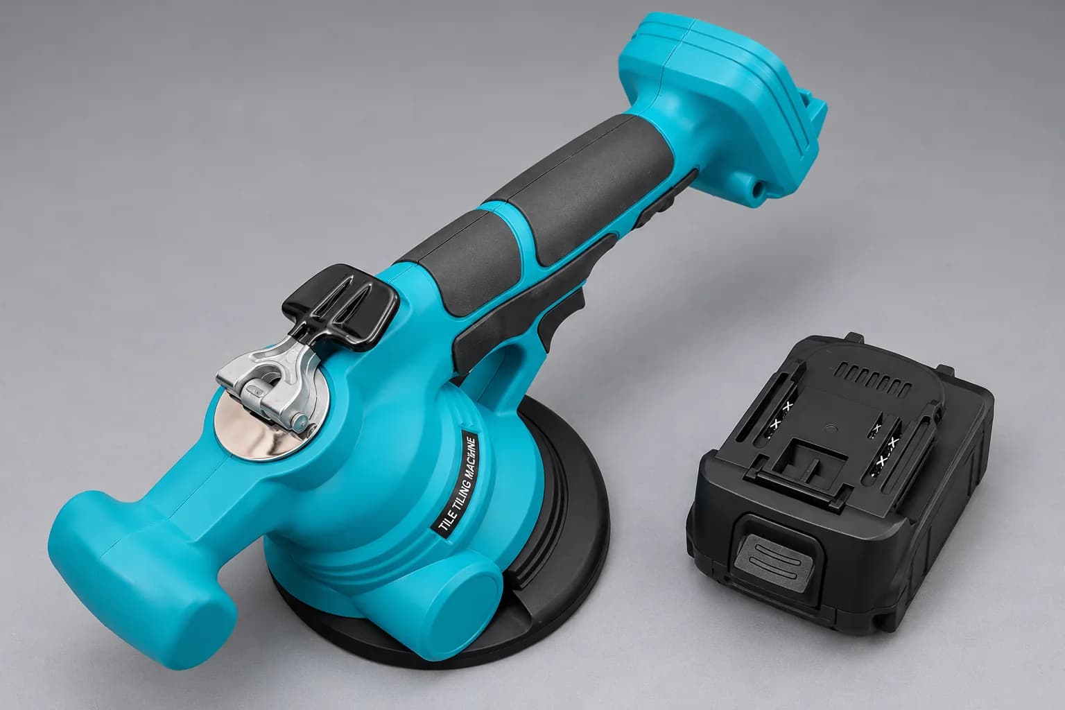 Turquoise cordless tile vibrator machine beside its battery